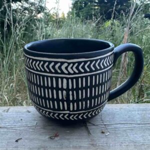 Creating Connections sharing circle in Nanaimo, BC on Vancouver Island. Photo of a mug on a rustic wood table outdoors.